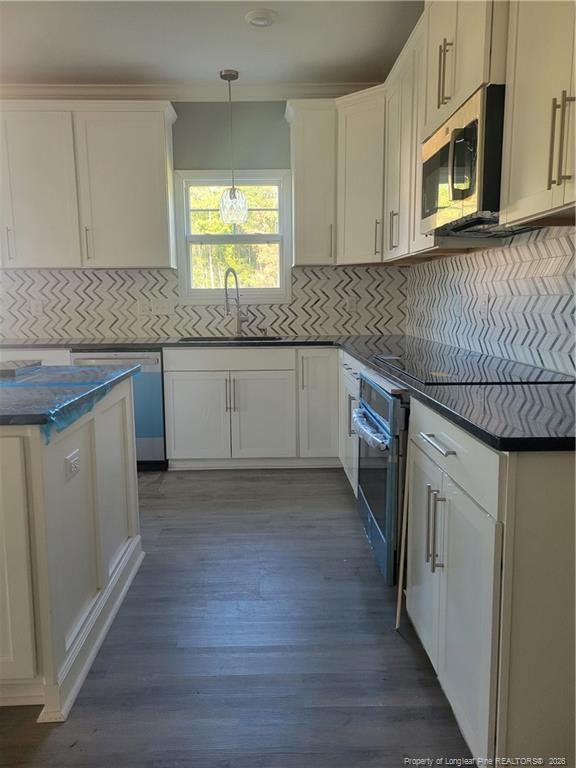 2960 H H Clark Road Fayetteville, NC 28306 - Photo 7 of 33 a kitchen with stainless steel appliances granite countertop a stove a sink and a microwave