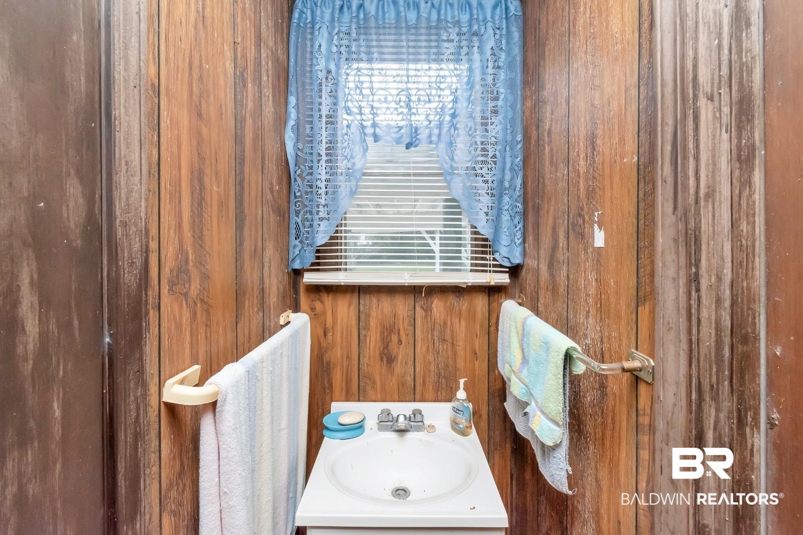 4305 Stein Street Mobile, AL 36608 - Photo 14 of 22 Bathroom featuring wood walls and sink