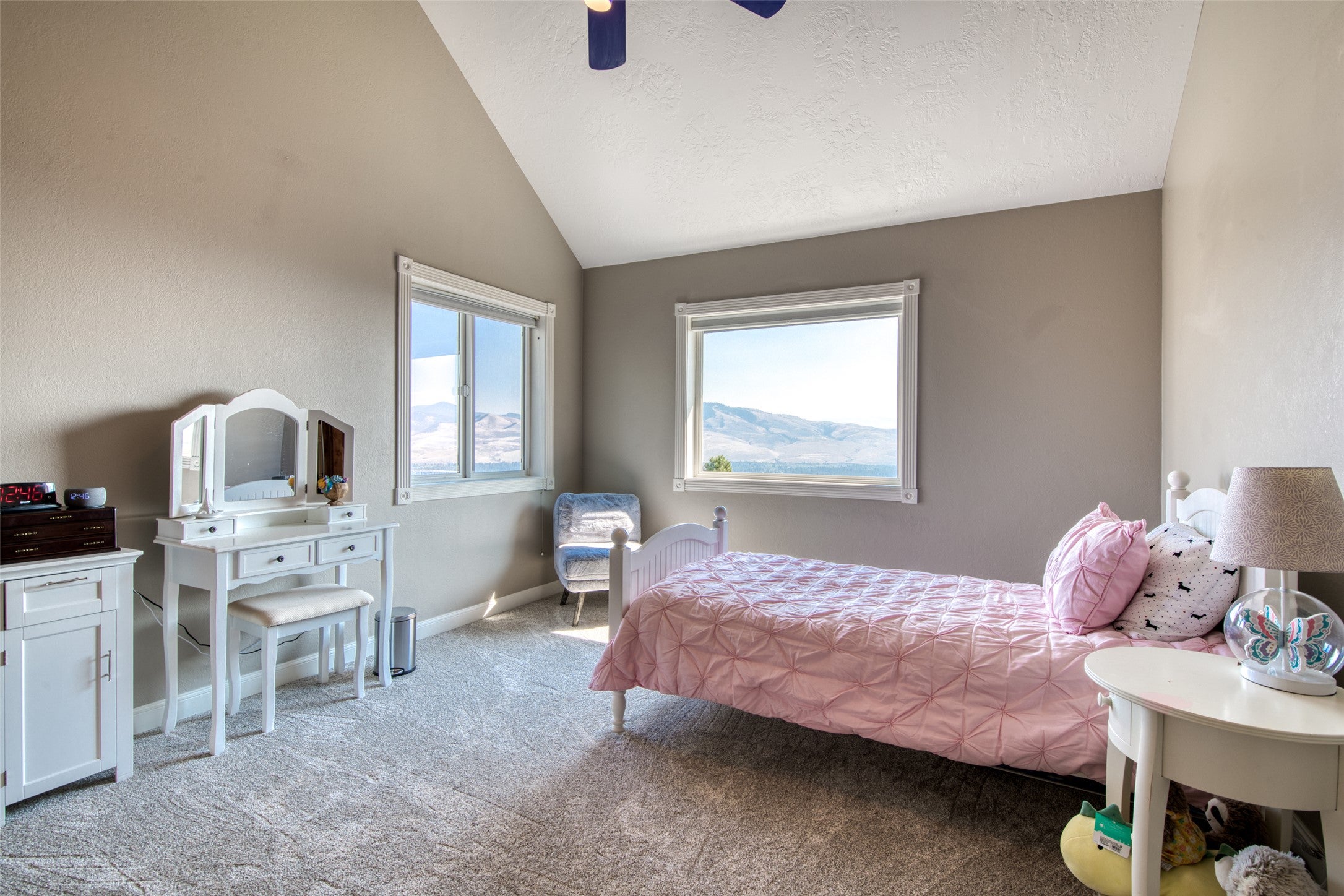 16374 Folsom Road Florence, MT 59833 - Photo 77 of 98 Bedroom with light colored carpet, a textured ceiling, a ceiling fan, and high vaulted ceiling