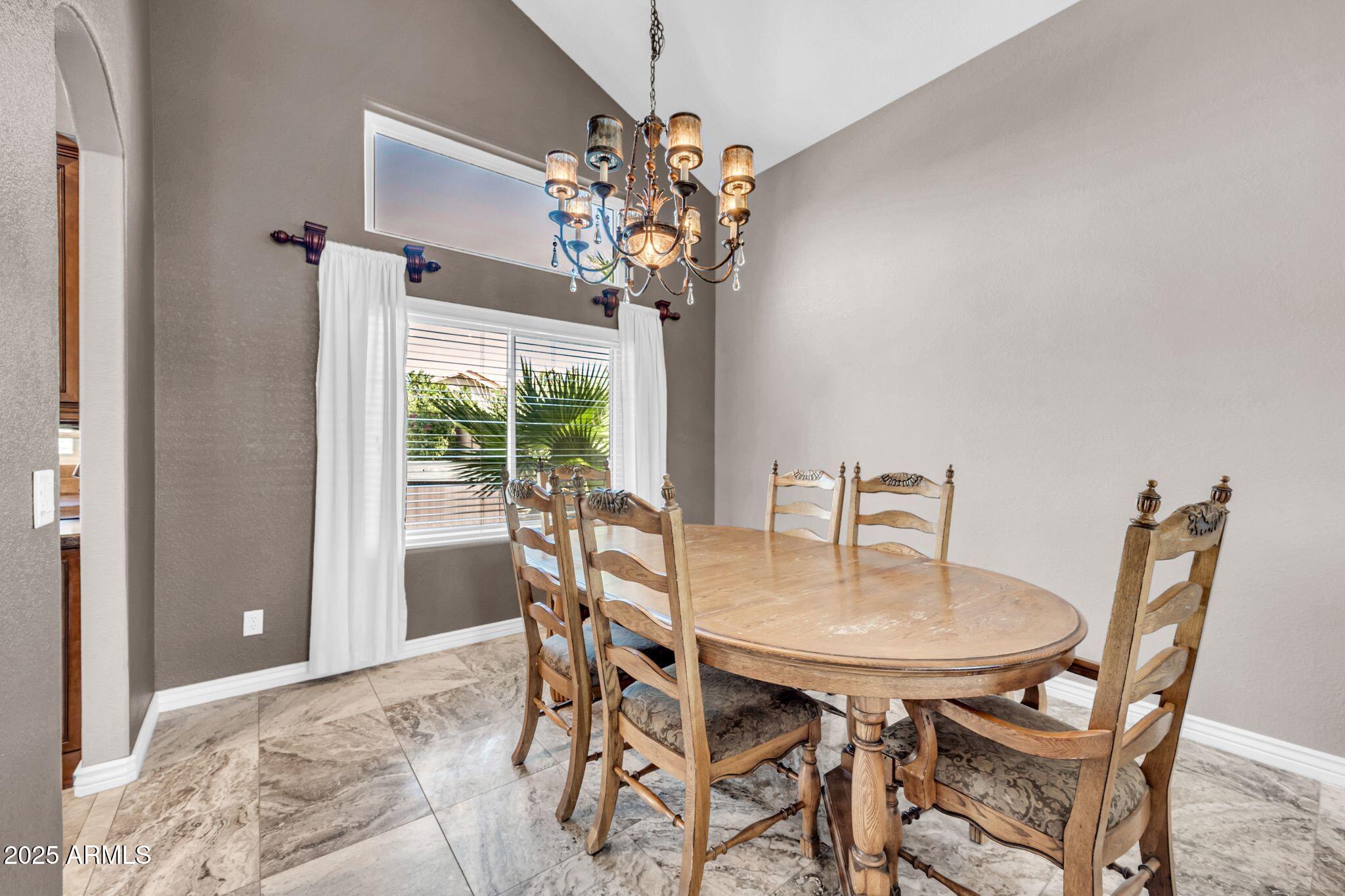 1302 West Winchester Way Chandler, AZ 85224 - Photo 11 of 61 a view of a dining room with furniture and chandelier