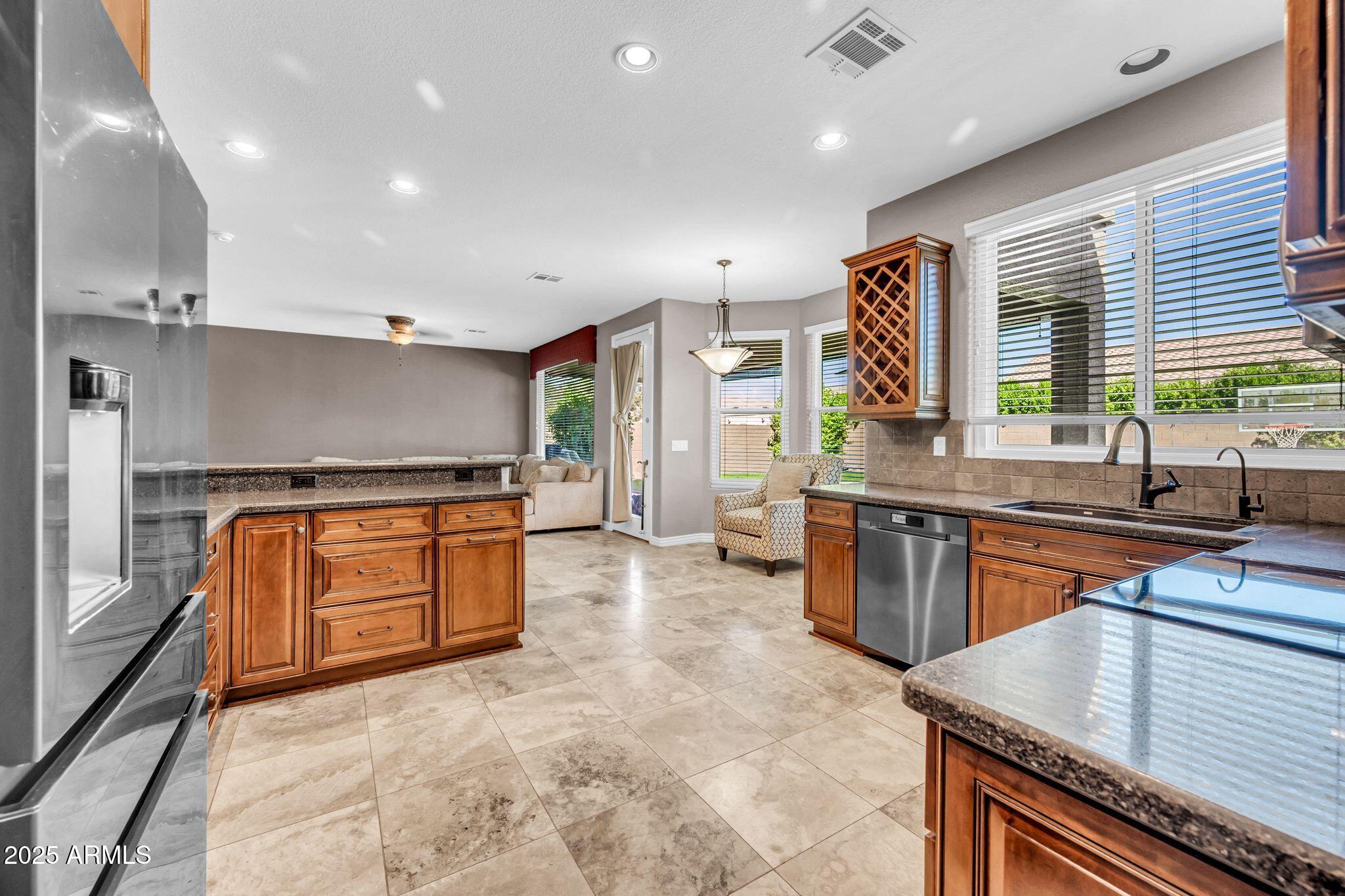 1302 West Winchester Way Chandler, AZ 85224 - Photo 15 of 61 a kitchen with stainless steel appliances granite countertop sink stove and refrigerator