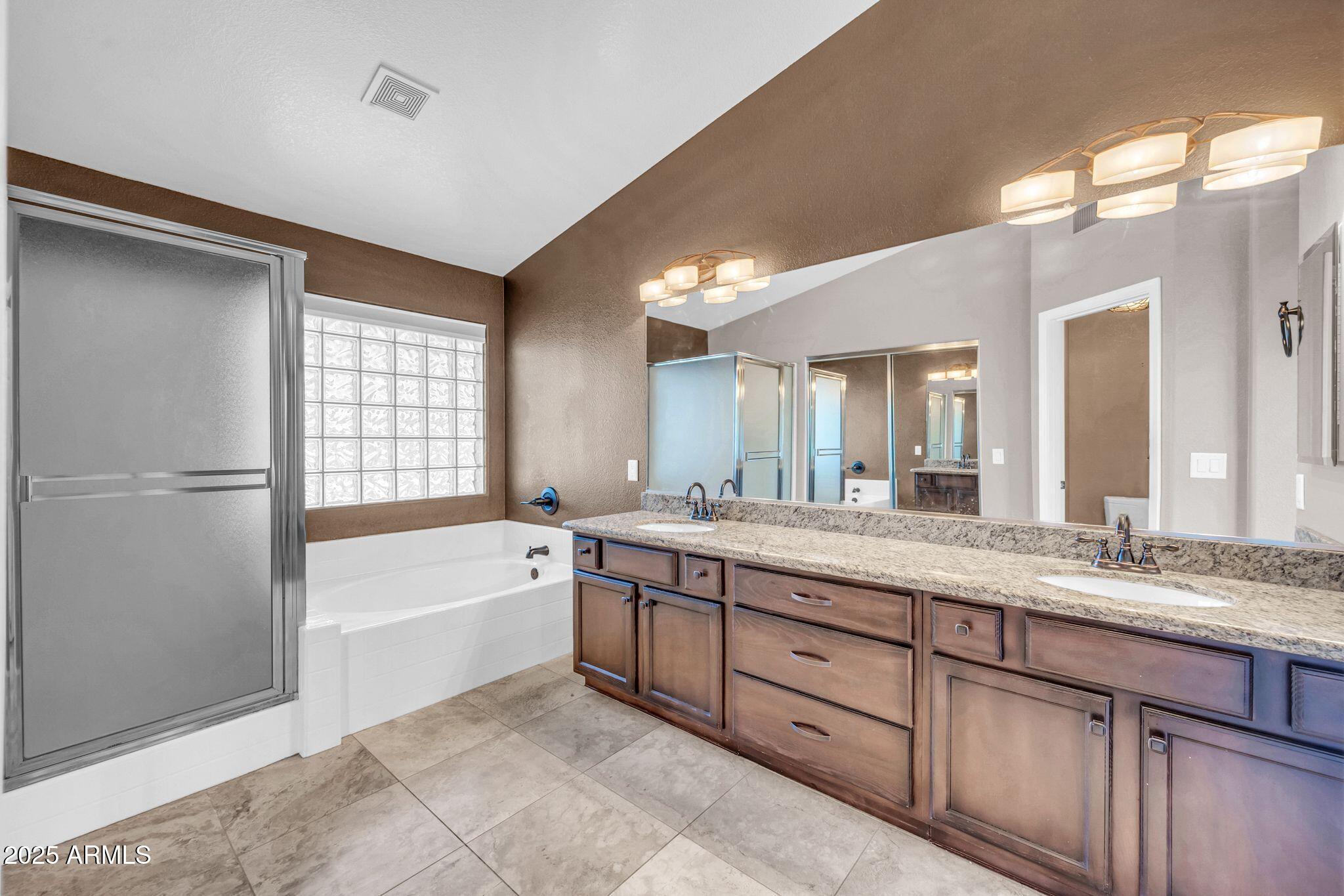 1302 West Winchester Way Chandler, AZ 85224 - Photo 17 of 61 a spacious bathroom with a granite countertop sink mirror and a bathtub