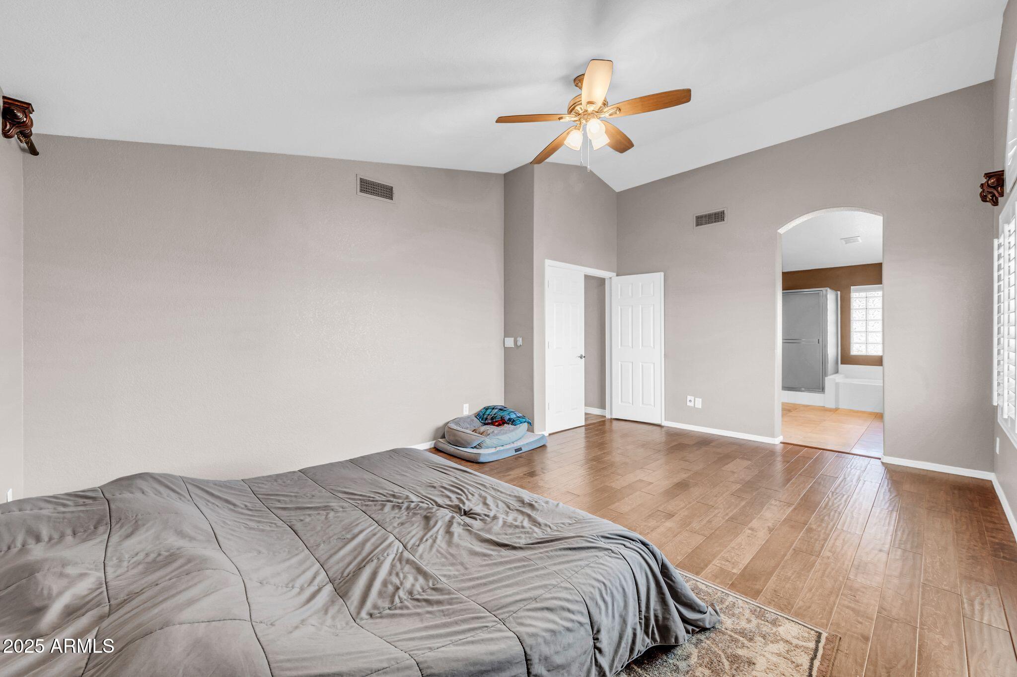 1302 West Winchester Way Chandler, AZ 85224 - Photo 19 of 61 a bedroom with a bed and a chandelier