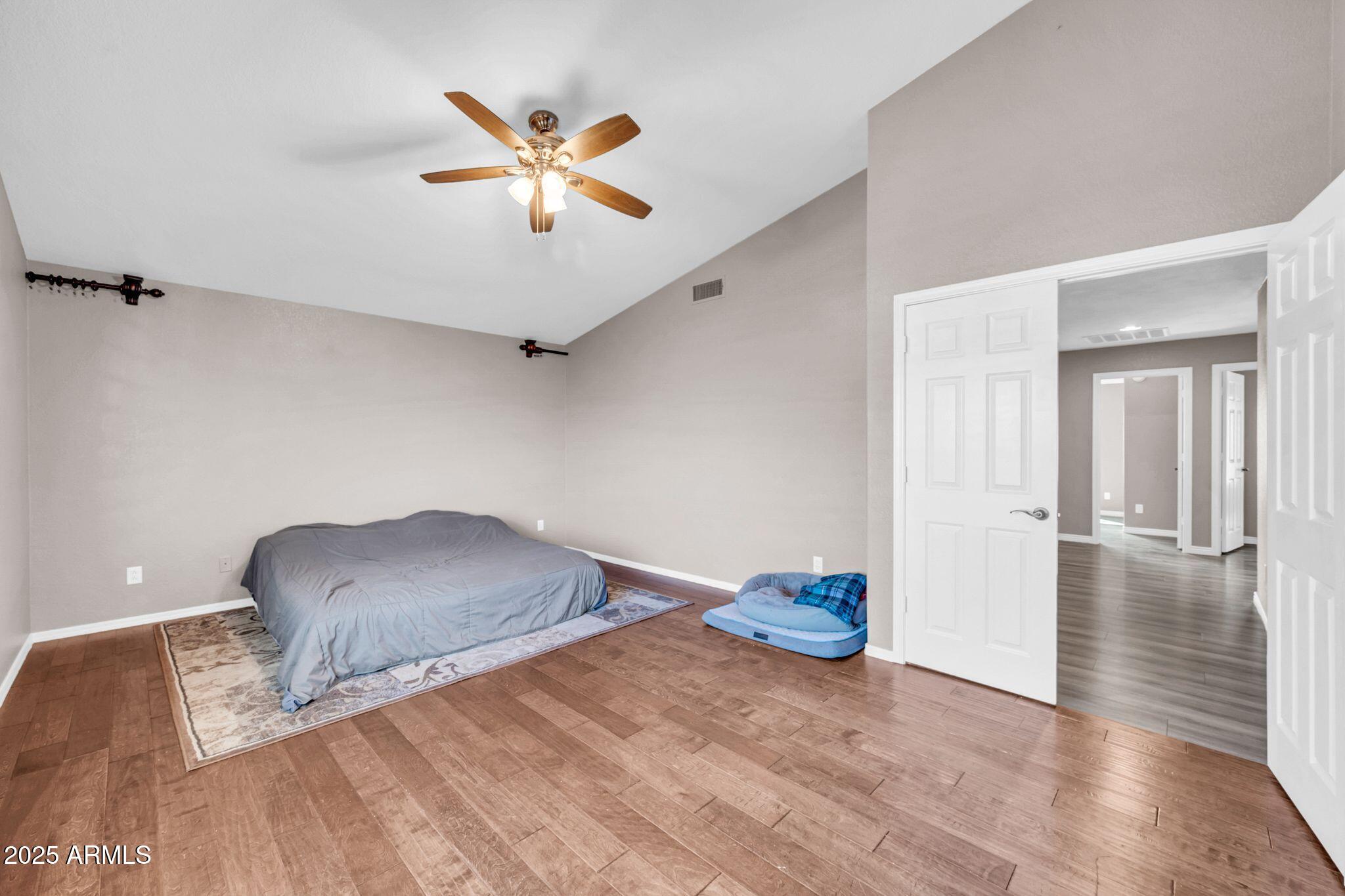 1302 West Winchester Way Chandler, AZ 85224 - Photo 20 of 61 a view of a livingroom with wooden floor and a ceiling fan