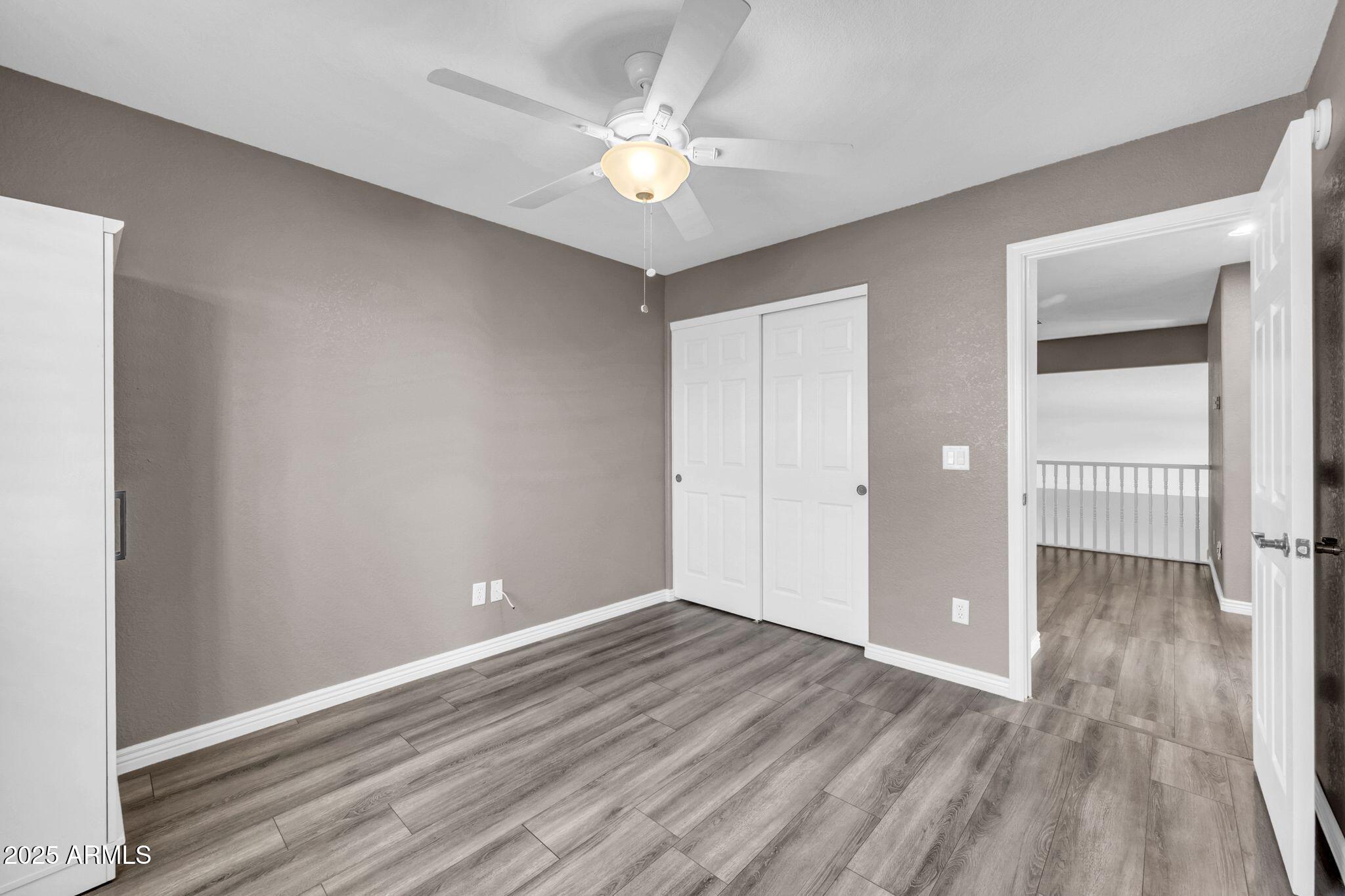 1302 West Winchester Way Chandler, AZ 85224 - Photo 23 of 61 wooden floor in an empty room with a window
