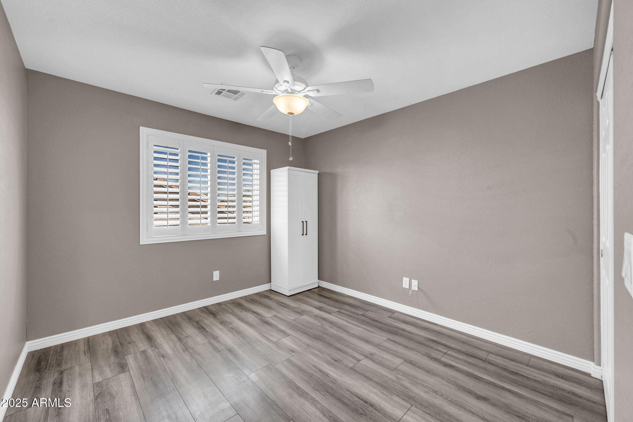 1302 West Winchester Way Chandler, AZ 85224 - Photo 24 of 61 wooden floor in an empty room with a window