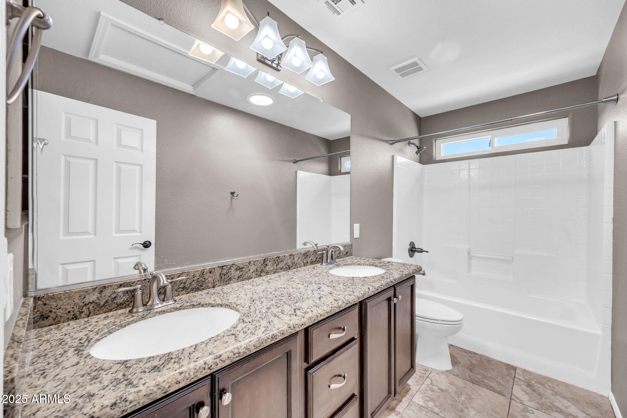 1302 West Winchester Way Chandler, AZ 85224 - Photo 25 of 61 a bathroom with a granite countertop double vanity sink and a mirror