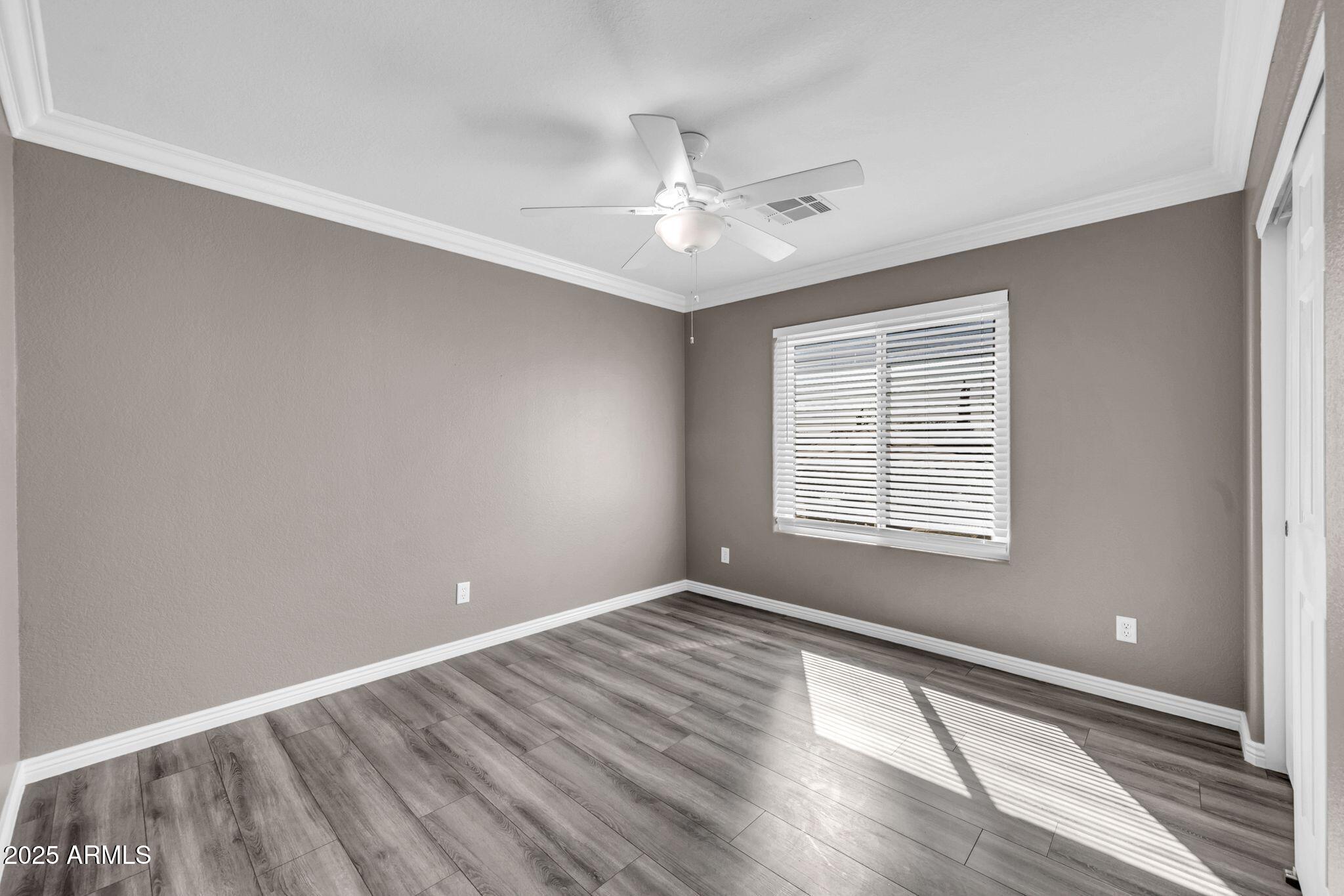 1302 West Winchester Way Chandler, AZ 85224 - Photo 29 of 61 a view of an empty room with wooden floor and a window