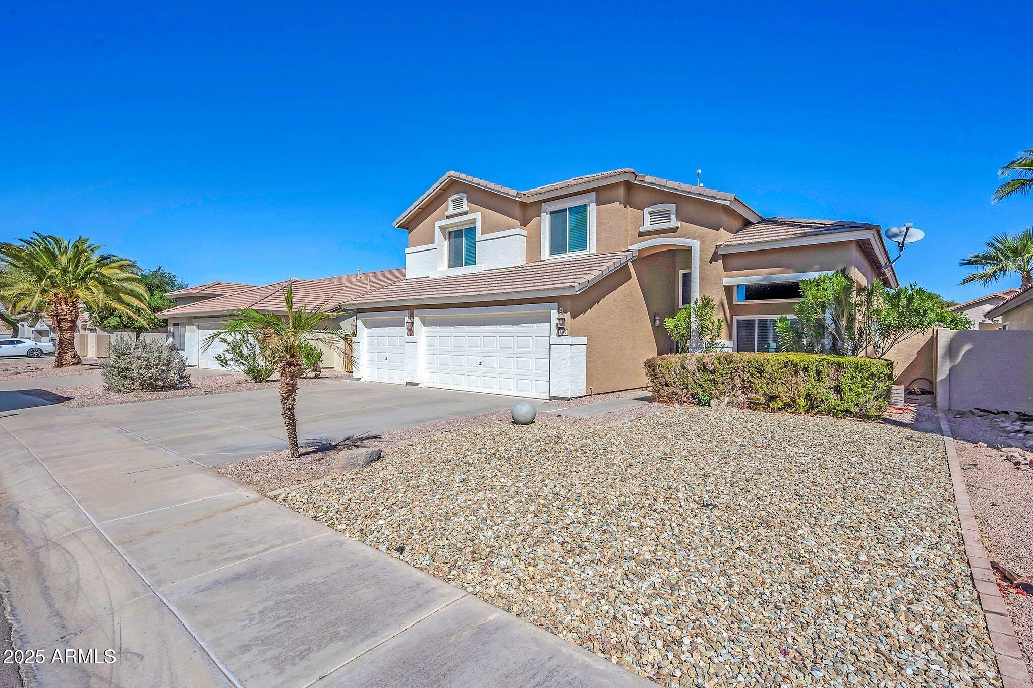 1302 West Winchester Way Chandler, AZ 85224 - Photo 40 of 61 a front view of a house with a yard and garage