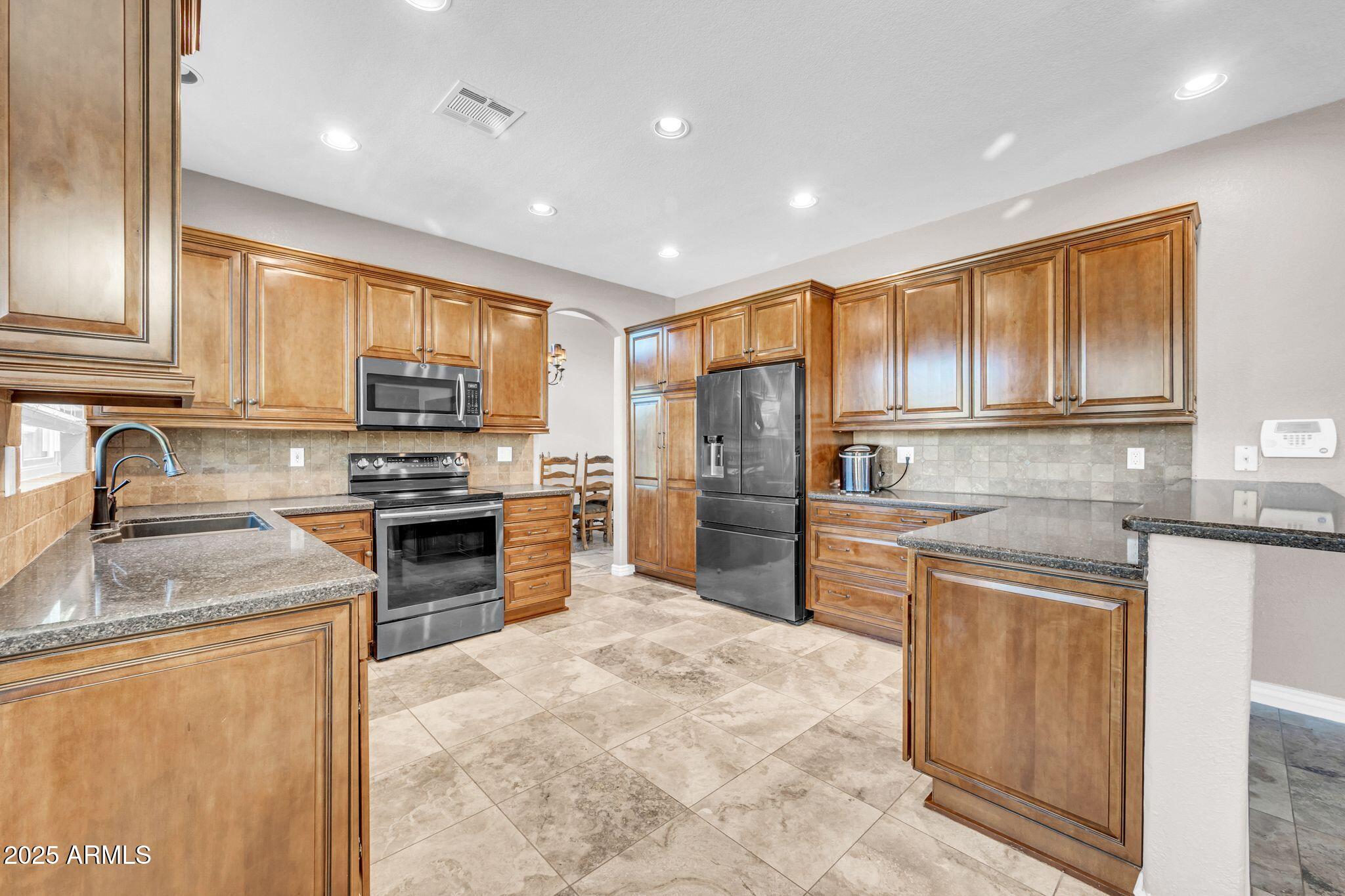 1302 West Winchester Way Chandler, AZ 85224 - Photo 5 of 61 a kitchen with granite countertop stainless steel appliances and cabinets