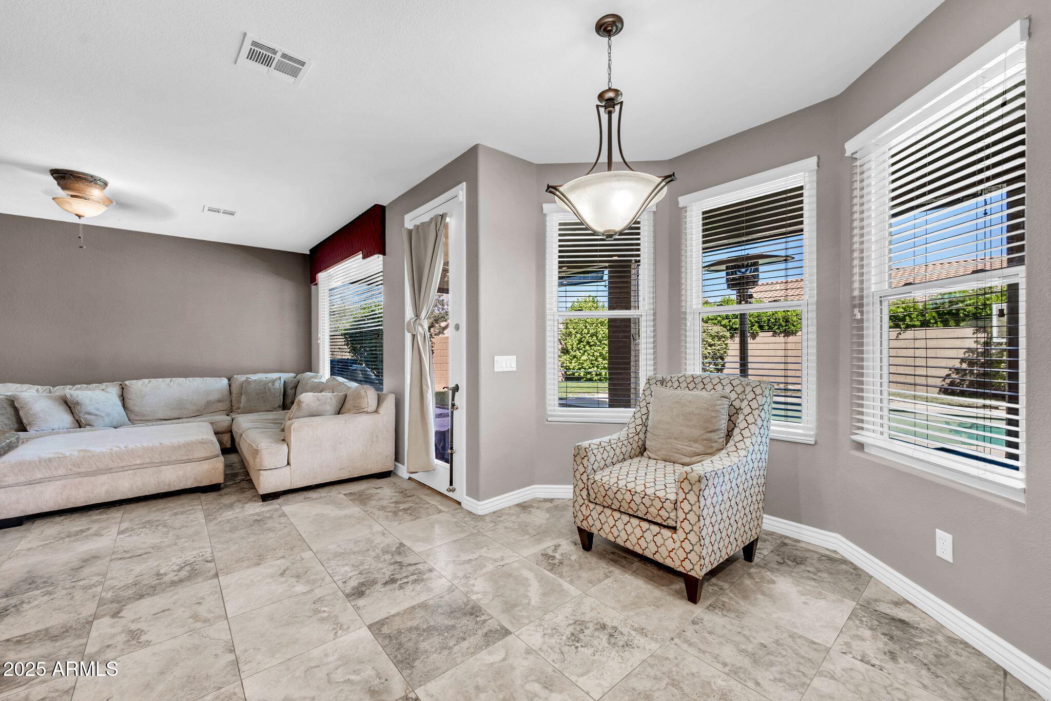1302 West Winchester Way Chandler, AZ 85224 - Photo 7 of 61 a living room with furniture and a chandelier