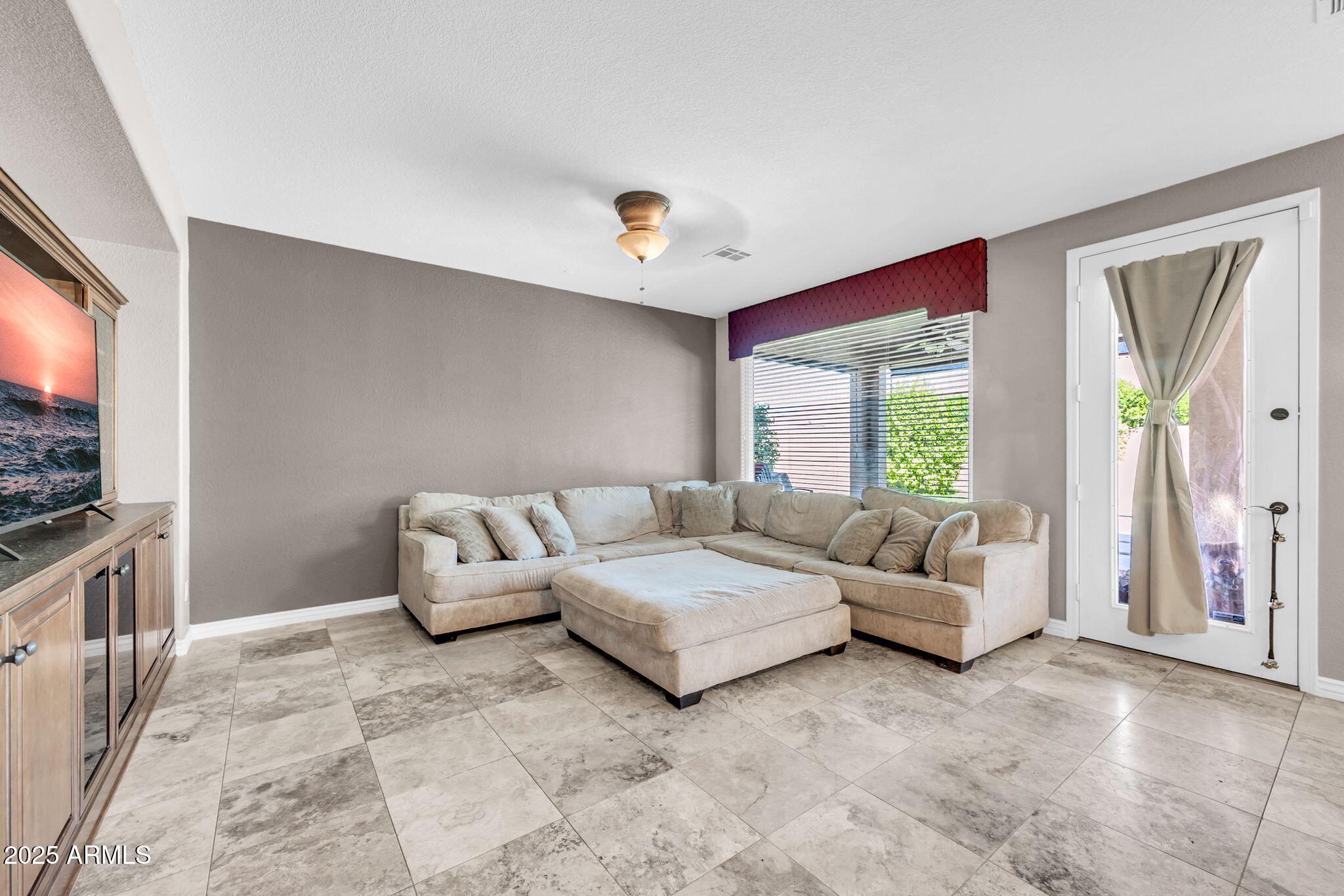 1302 West Winchester Way Chandler, AZ 85224 - Photo 8 of 61 a living room with furniture and a flat screen tv