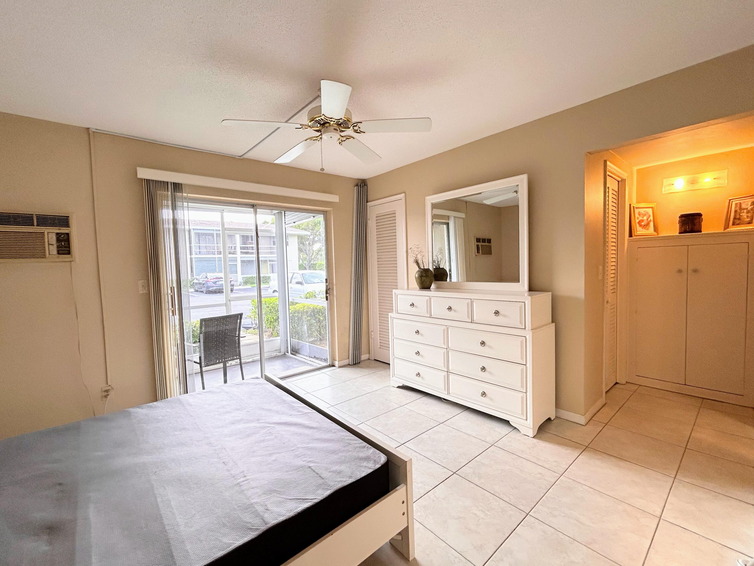 680 Horizon West, Unit 103 Boynton Beach, FL 33435 - Photo 17 of 61 a spacious bedroom with a large bed and a dresser