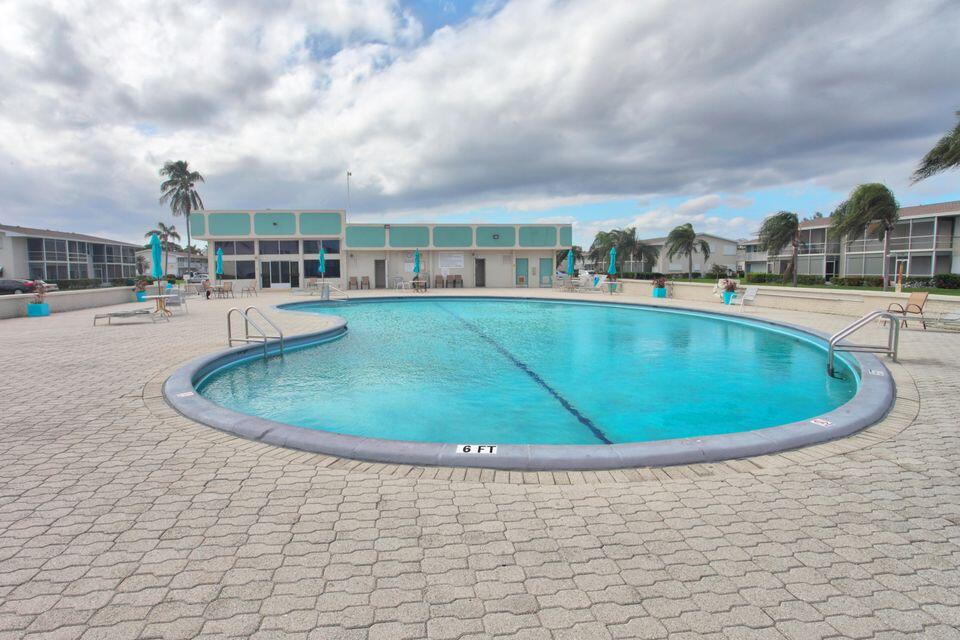 680 Horizon West, Unit 103 Boynton Beach, FL 33435 - Photo 22 of 61 a view of a swimming pool with a yard