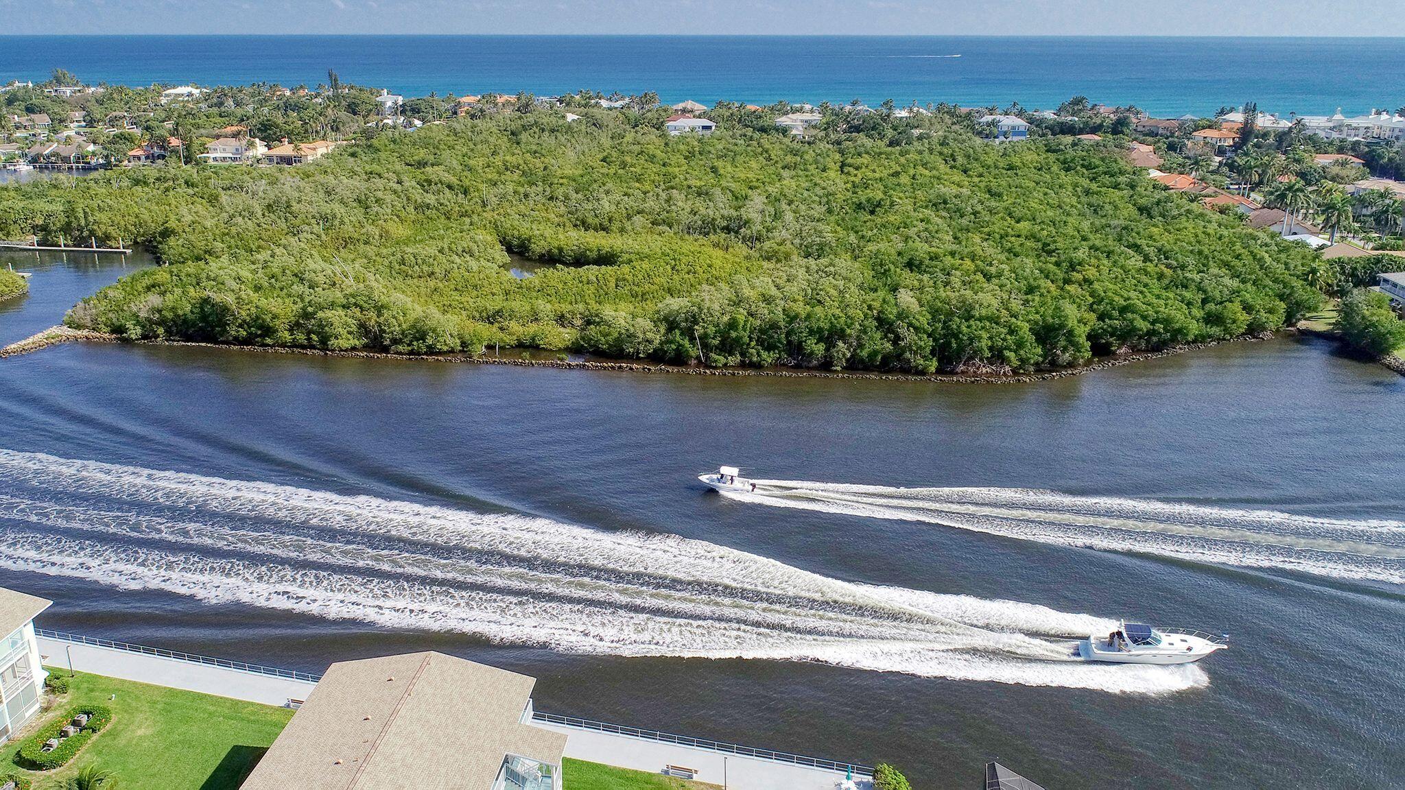 680 Horizon West, Unit 103 Boynton Beach, FL 33435 - Photo 31 of 61 a view of a lake with a mountain in the background