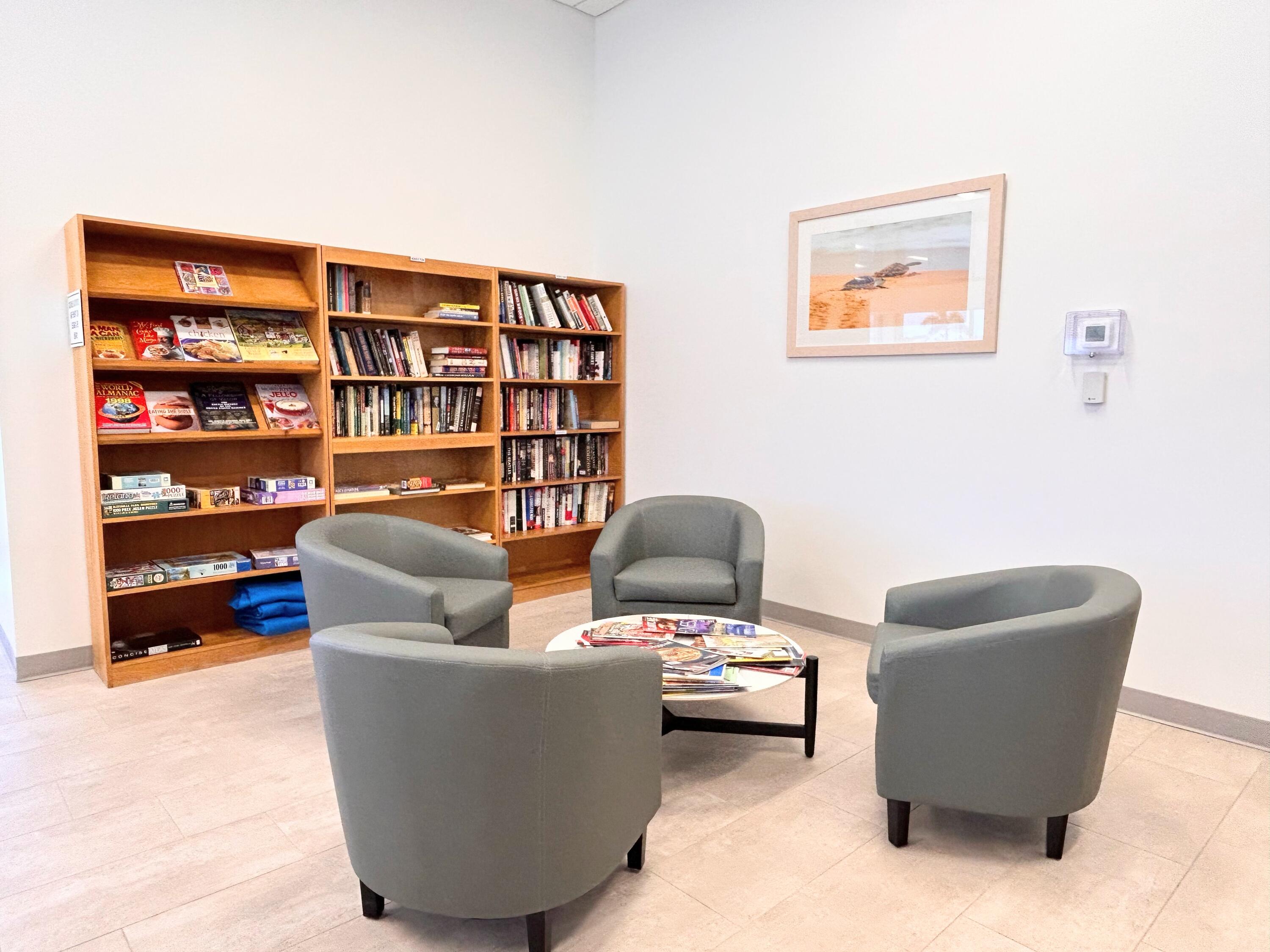 680 Horizon West, Unit 103 Boynton Beach, FL 33435 - Photo 42 of 61 a living room with furniture and a book shelf