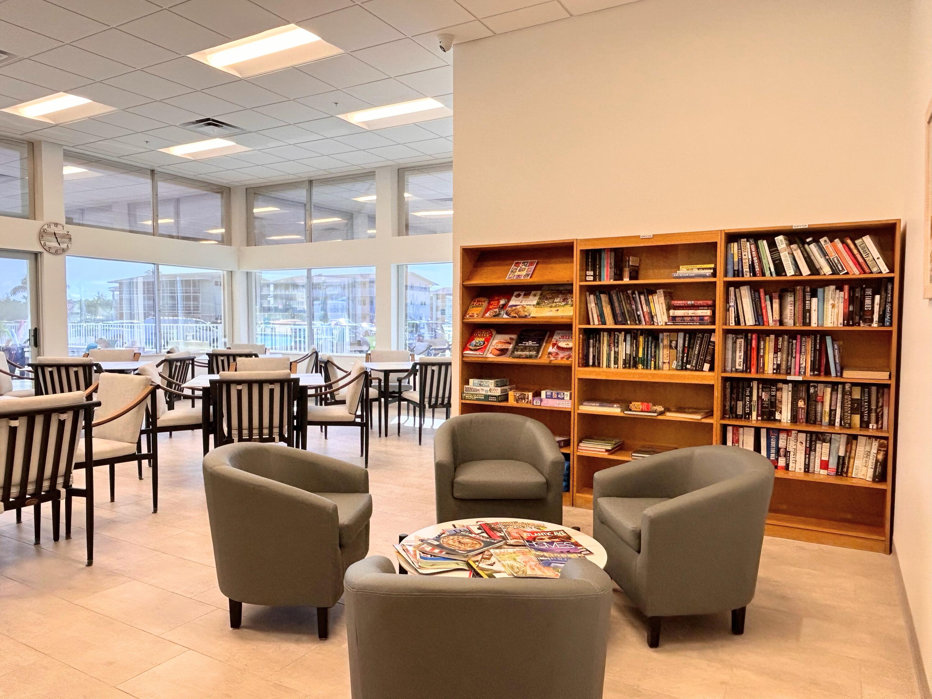 680 Horizon West, Unit 103 Boynton Beach, FL 33435 - Photo 47 of 61 a living room with furniture a bookshelf and a book shelf
