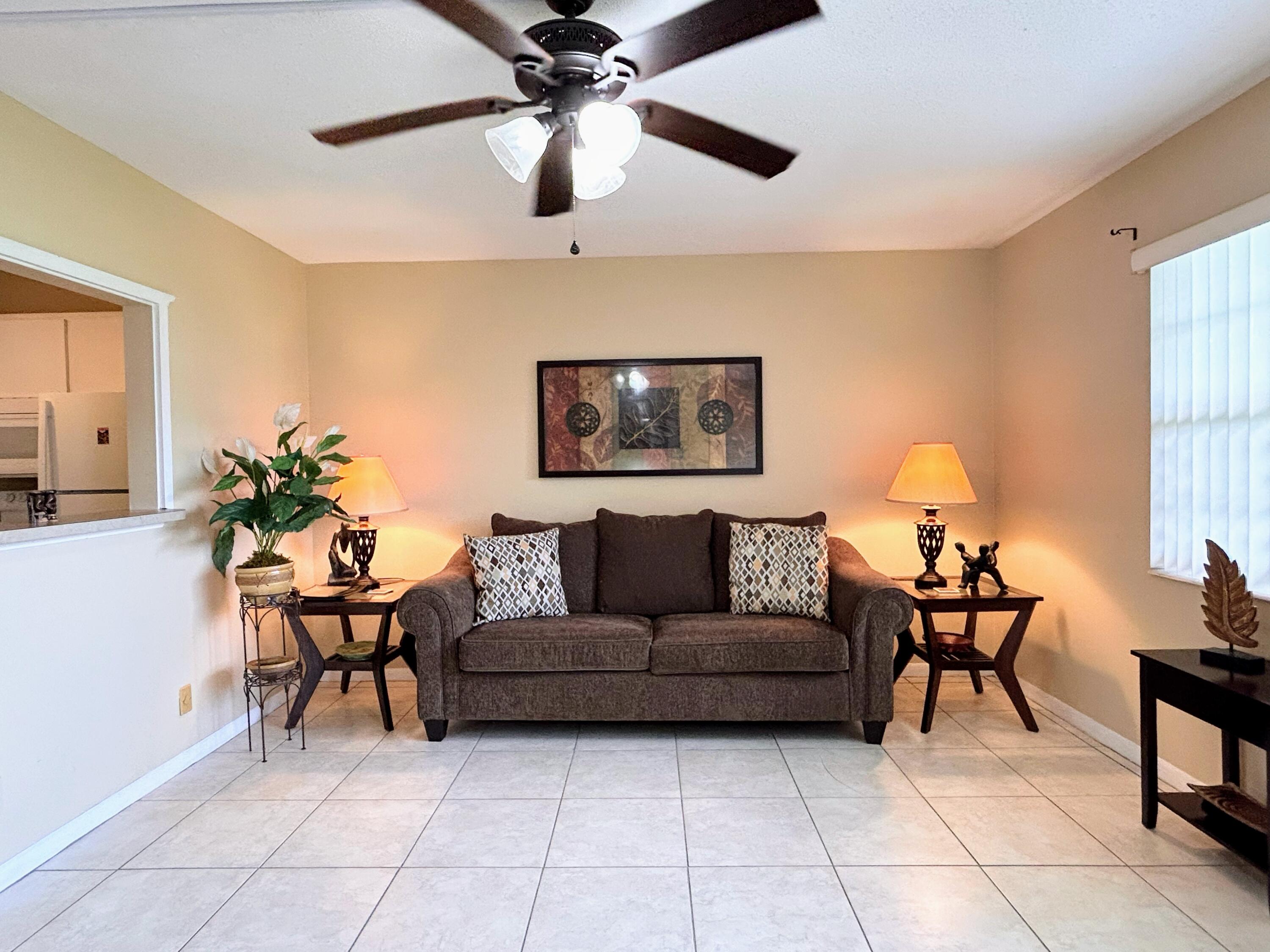680 Horizon West, Unit 103 Boynton Beach, FL 33435 - Photo 5 of 61 a living room with furniture and a chandelier
