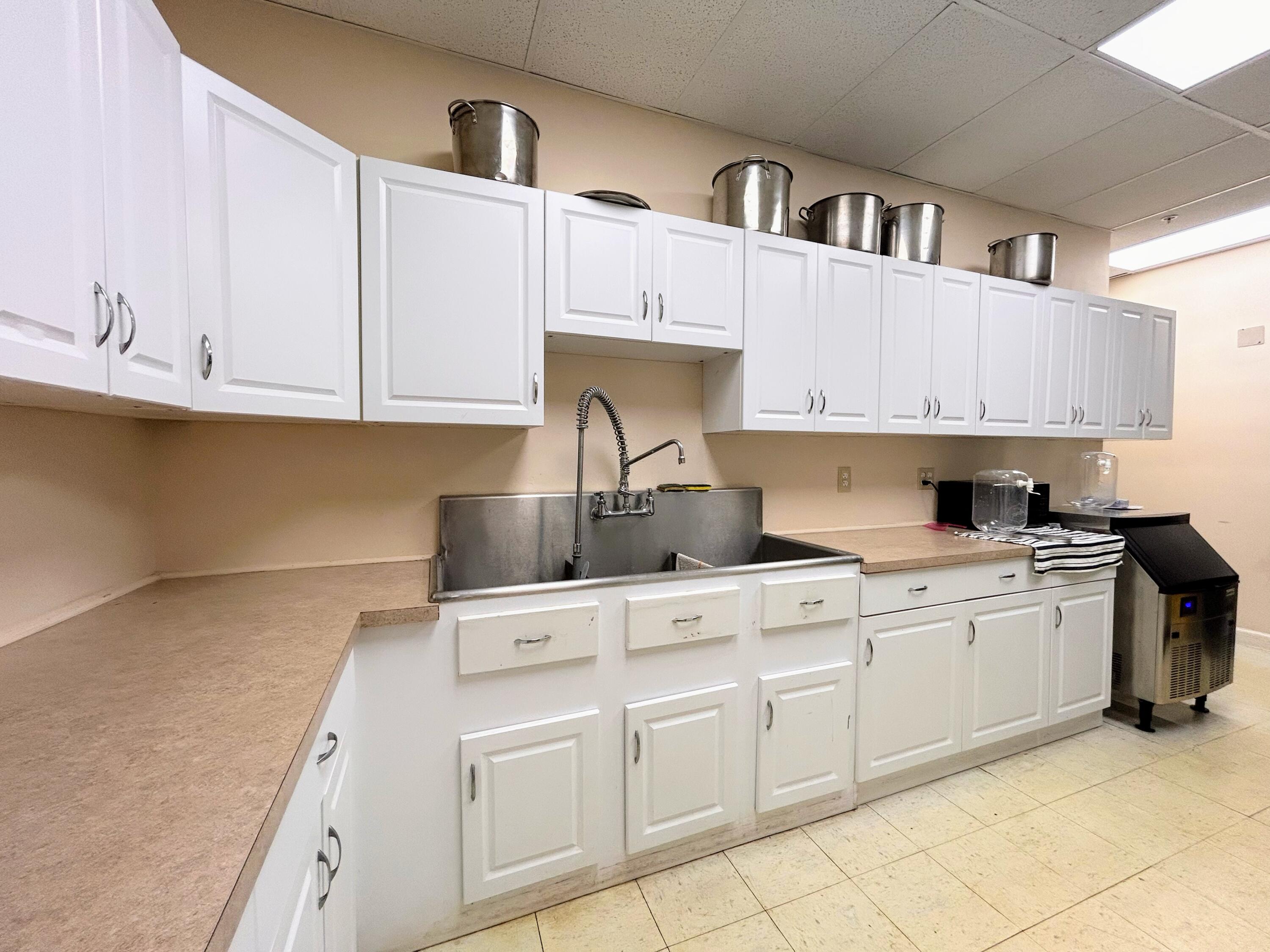 680 Horizon West, Unit 103 Boynton Beach, FL 33435 - Photo 56 of 61 a kitchen with stainless steel appliances granite countertop a sink and cabinets