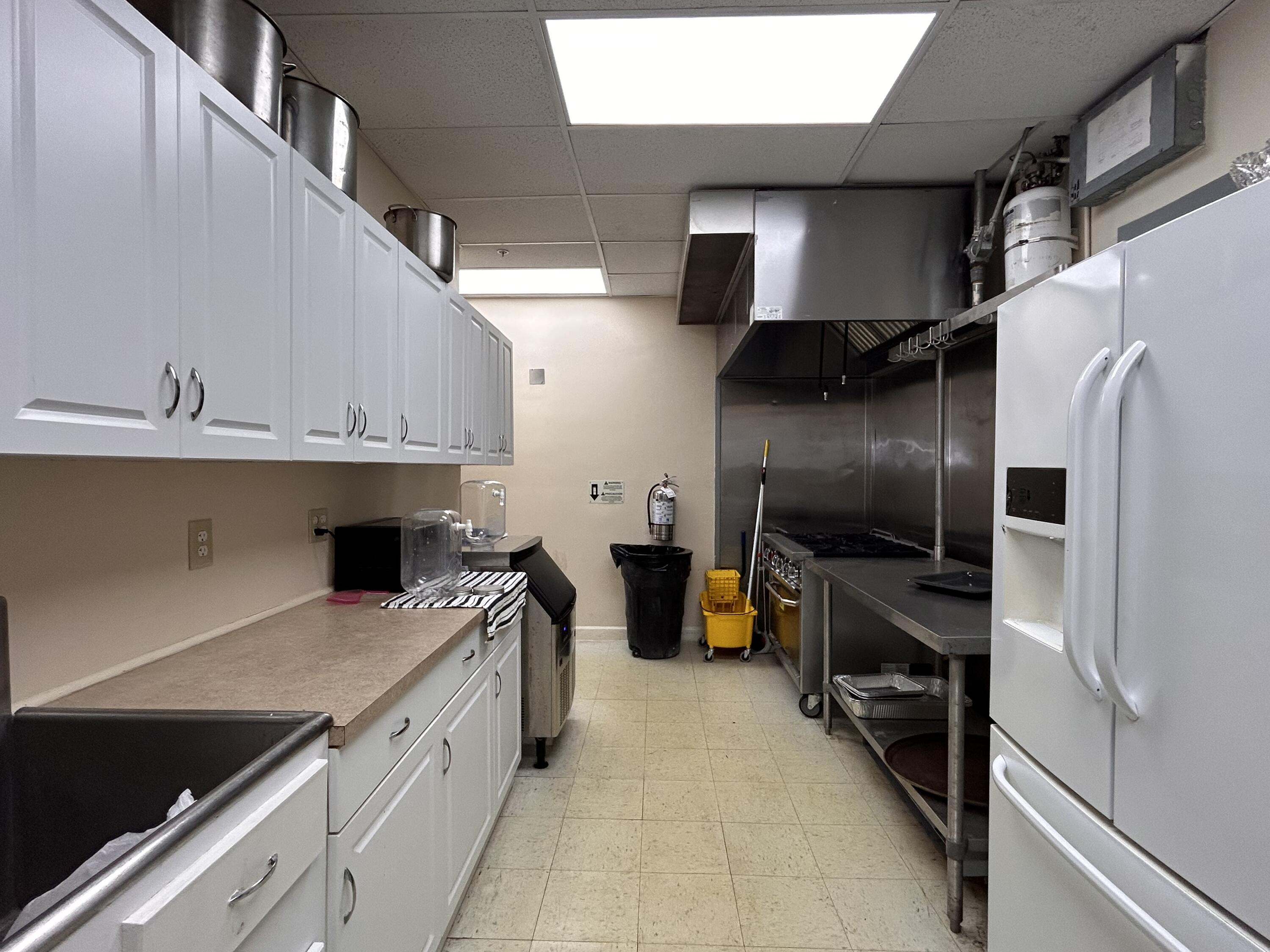 680 Horizon West, Unit 103 Boynton Beach, FL 33435 - Photo 57 of 61 a kitchen with a refrigerator and a sink