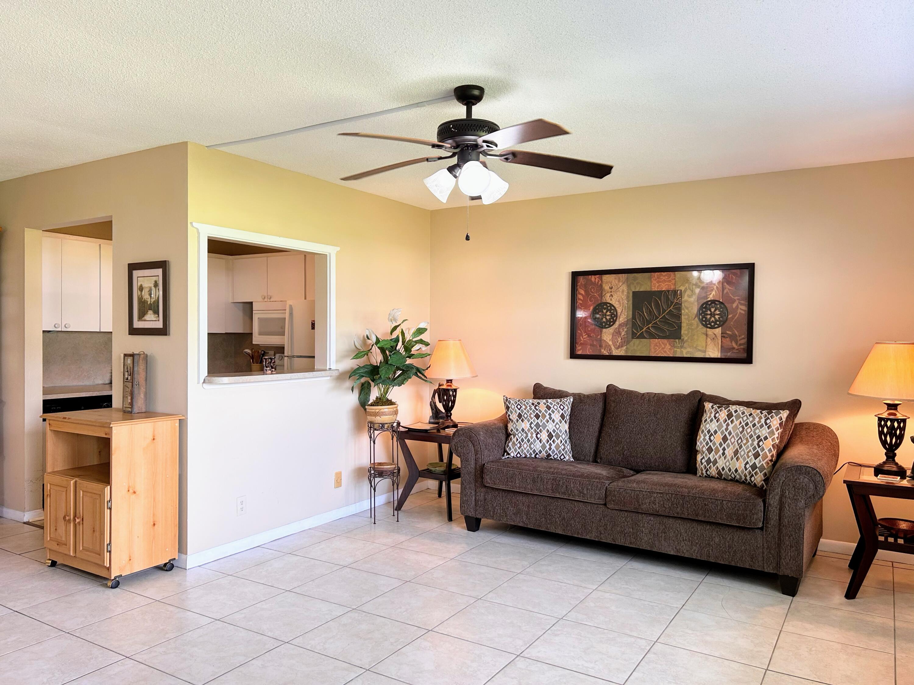 680 Horizon West, Unit 103 Boynton Beach, FL 33435 - Photo 6 of 61 a living room with furniture and wooden floor