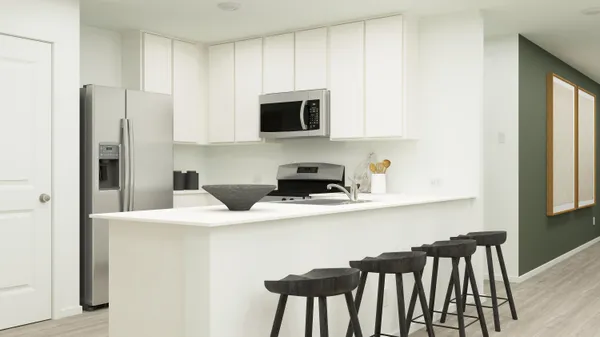 a kitchen with stainless steel appliances a microwave a sink and white cabinets