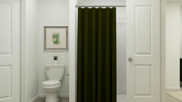 a white toilet sitting next to a bathroom sink