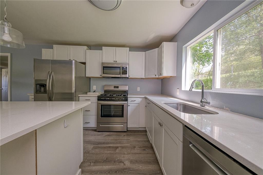 531 West Ingomar Road Pittsburgh, PA 15237 - Photo 5 of 35 a kitchen with kitchen island granite countertop a sink appliances cabinets and counter space