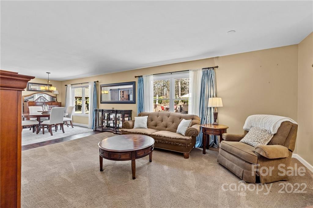 8241 Fairfield Forest Road Denver, NC 28037 - Photo 25 of 48 a living room with furniture and a large window