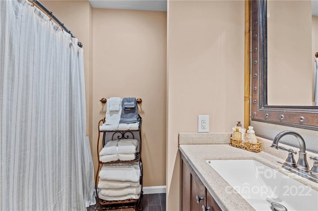 8241 Fairfield Forest Road Denver, NC 28037 - Photo 27 of 48 a bathroom with a granite countertop sink and a mirror