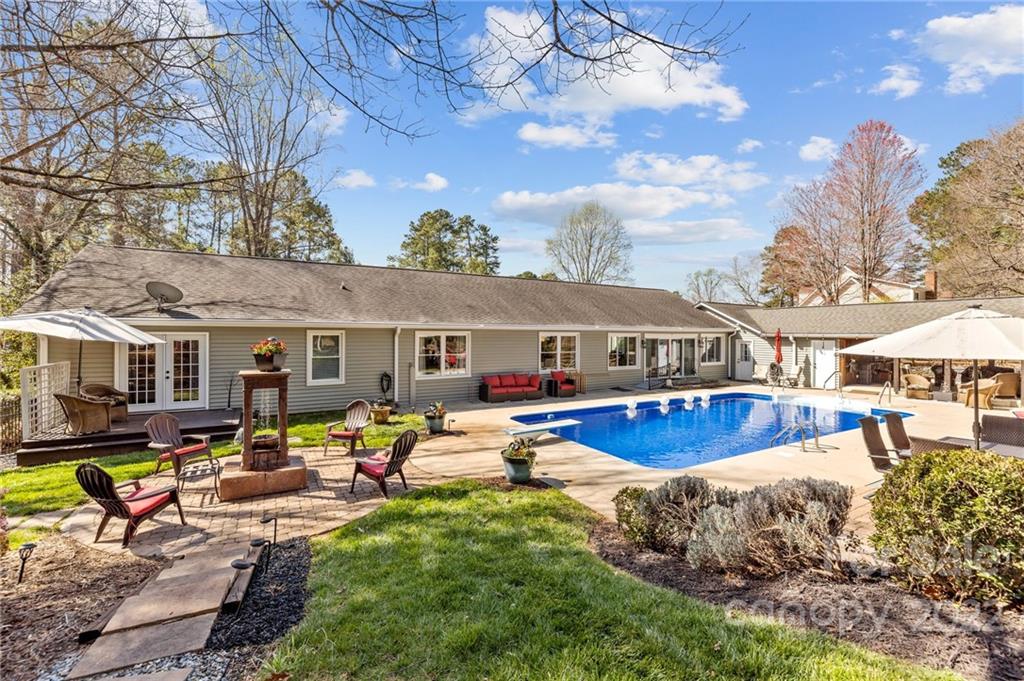 8241 Fairfield Forest Road Denver, NC 28037 - Photo 3 of 48 a view of a house with swimming pool and sitting area