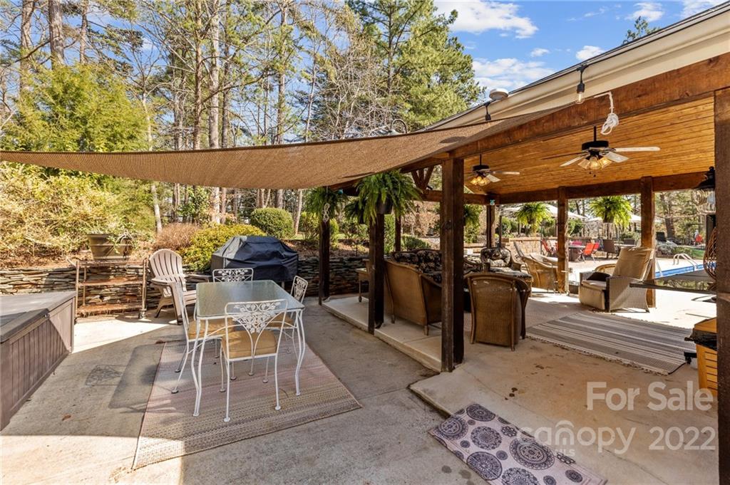 8241 Fairfield Forest Road Denver, NC 28037 - Photo 36 of 48 a view of a patio with a dining table and chairs with wooden floor