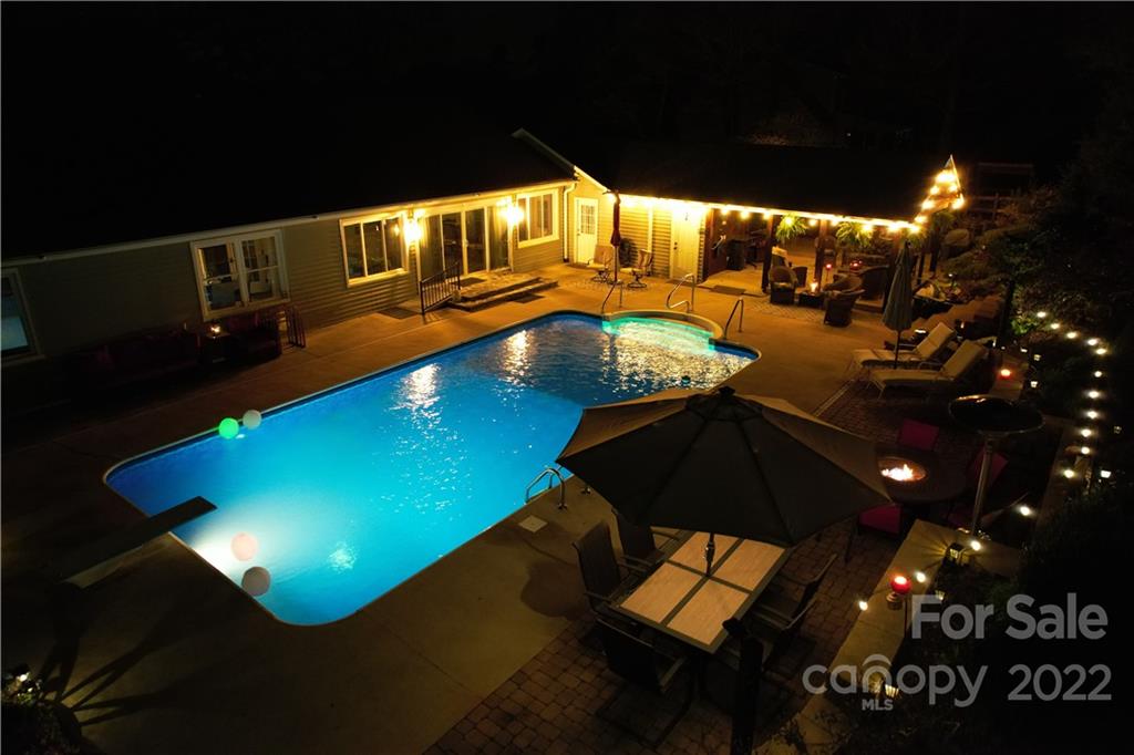 8241 Fairfield Forest Road Denver, NC 28037 - Photo 4 of 48 a view of a swimming pool with an outdoor space and seating area