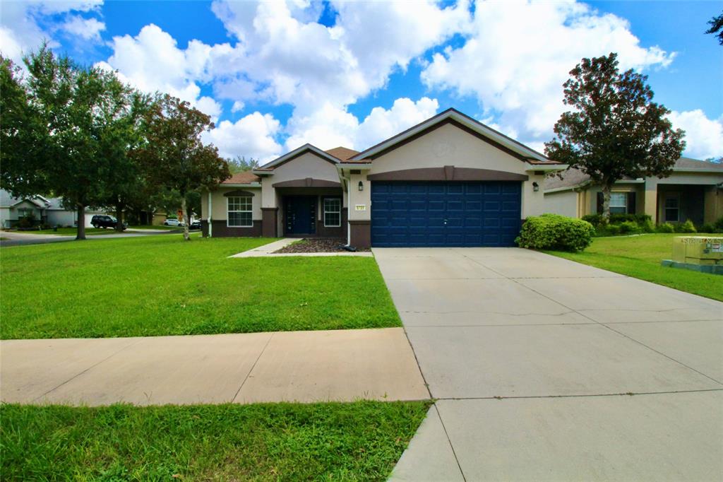 5739 Southwest 40th Street Ocala, FL 34474 - Photo 1 of 52 a front view of house with yard and green space