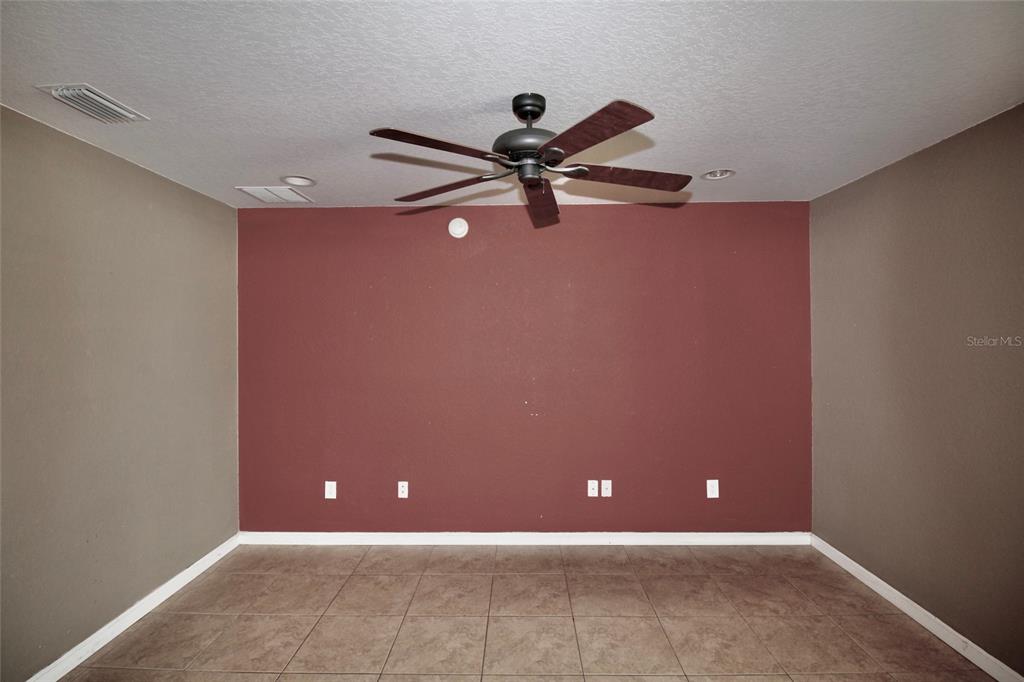 5739 Southwest 40th Street Ocala, FL 34474 - Photo 12 of 52 a view of a room with a ceiling fan and a window