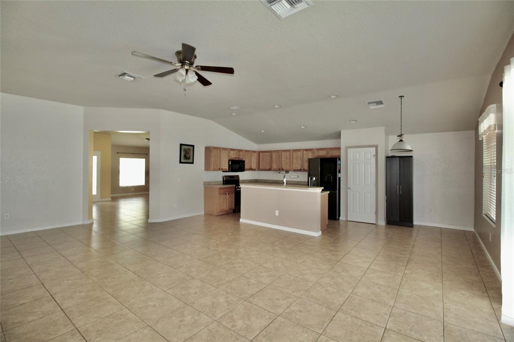 5739 Southwest 40th Street Ocala, FL 34474 - Photo 15 of 52 a view of a kitchen with a sink and dishwasher a refrigerator with white cabinets