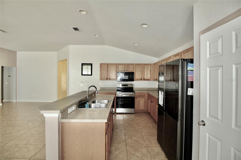 5739 Southwest 40th Street Ocala, FL 34474 - Photo 18 of 52 a kitchen that has a sink and a refrigerator