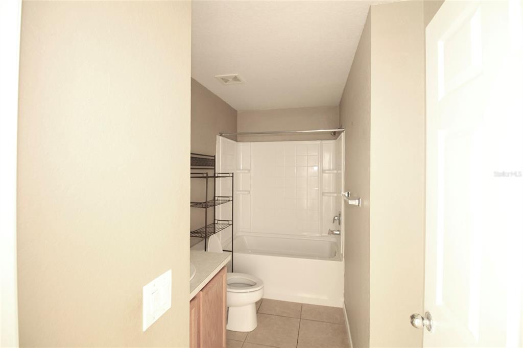 5739 Southwest 40th Street Ocala, FL 34474 - Photo 27 of 52 a bathroom with a shower and a toilet