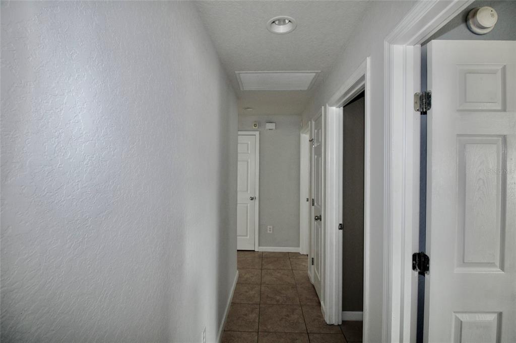 5739 Southwest 40th Street Ocala, FL 34474 - Photo 31 of 52 a view of a hallway with a wooden floor