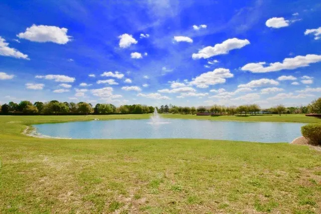 a view of a swimming pool and a yard