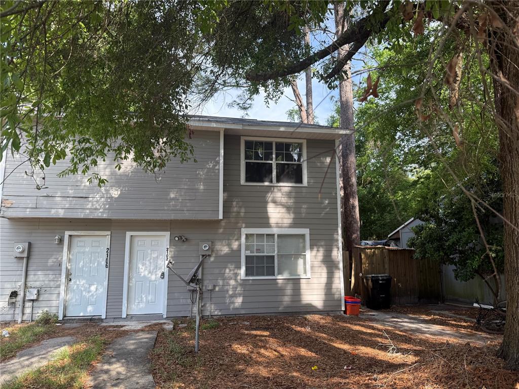 2102 Southwest 69th Drive Gainesville, FL 32607 - Photo 1 of 1 a front view of a house with a yard and garage