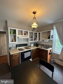 a kitchen with stainless steel appliances granite countertop a stove and a sink