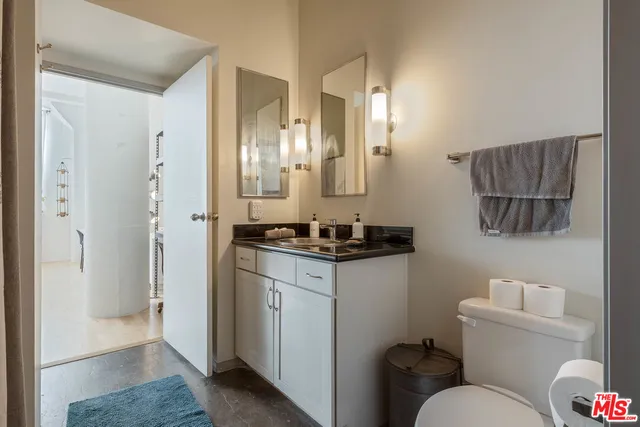 a bathroom with a toilet sink and shower