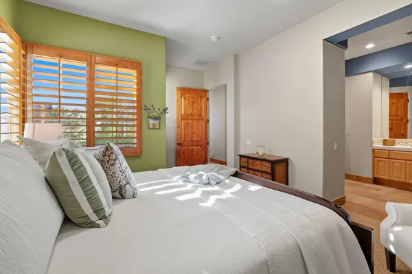 a bedroom with two beds and a lamp