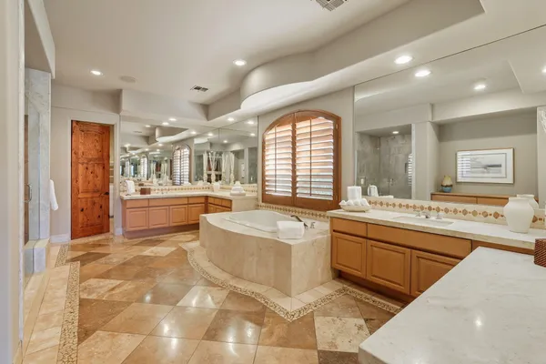 a large spacious bathroom with a large tub and sink