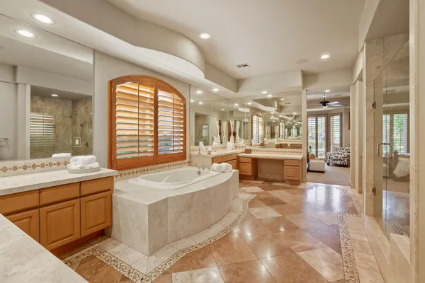 a bathroom with a glass shower door and a bathtub