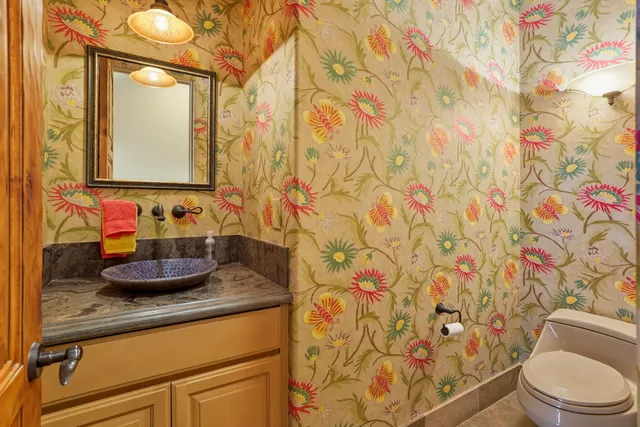 a bathroom with a granite countertop sink a mirror and a shower