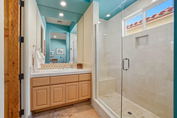 a bathroom with a granite countertop sink and a mirror