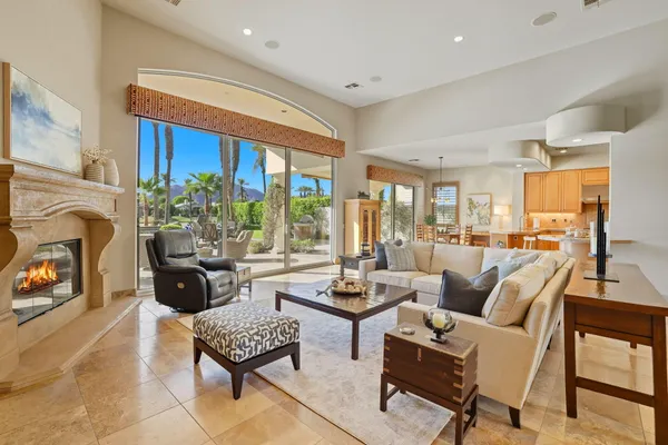 a living room with furniture fireplace and a large window