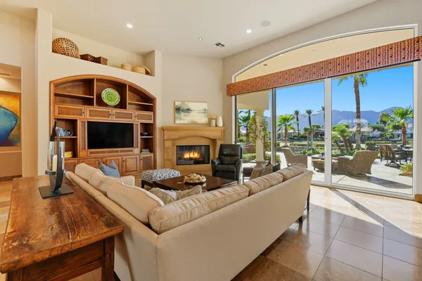 a living room with furniture fireplace and flat screen tv